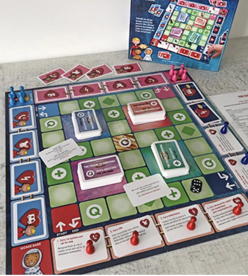 The Chain of Survival first aid board game set out with cards, counters and dice